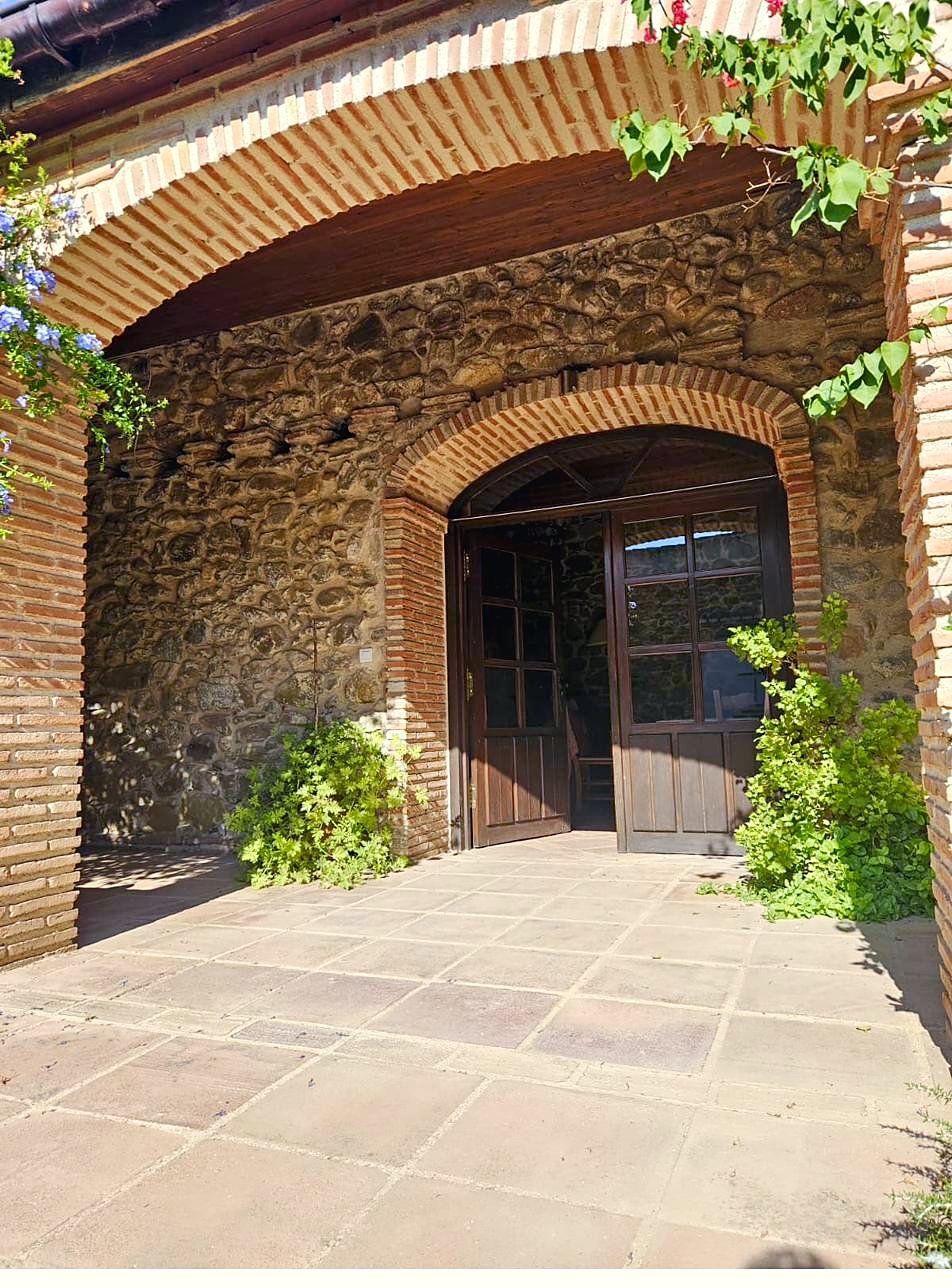 Arched stone entrance to the main house
